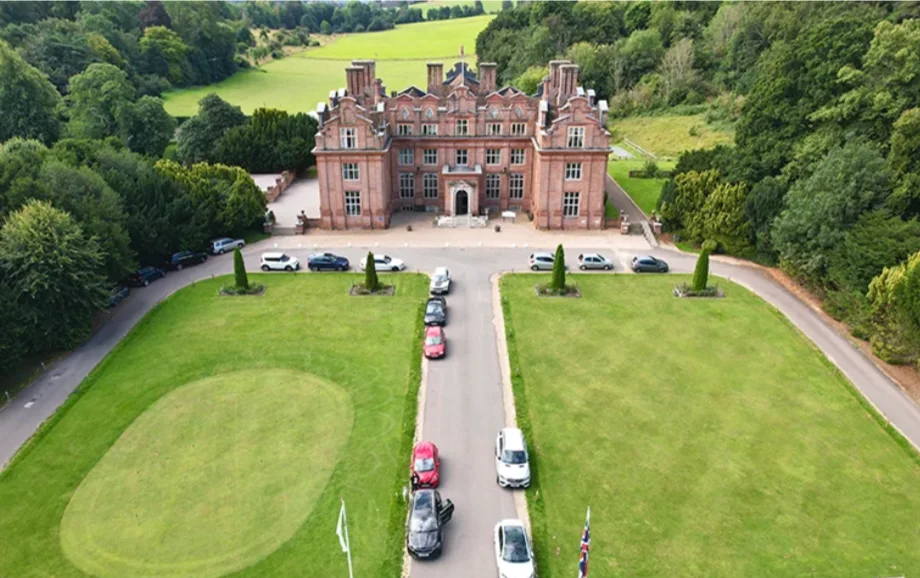 Zoomed out shot of the front exterior and grounds of Broome Park Hotel